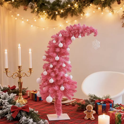 Prelit pink tilted tinsel Christmas tree sparkly and festive.